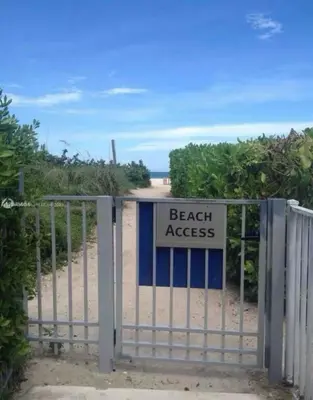 a gate with a beach access sign on it at OCEAN VIEW 1BR 2BA BEACH CONDO Parking in Miami Beach