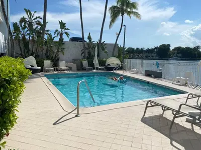 a swimming pool with two people in the water at OCEAN VIEW 1BR 2BA BEACH CONDO Parking in Miami Beach