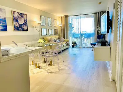a living room with a table and a couch at OCEAN VIEW 1BR 2BA BEACH CONDO Parking in Miami Beach