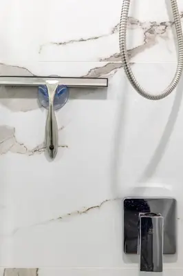 a spoon and a cell phone on a shelf at Nice,Stylish King Bed Studio in Miami Gardens