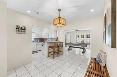 a kitchen and dining room with a pool table at Beach Home Estate I Pool & Ocean in Fort Lauderdale