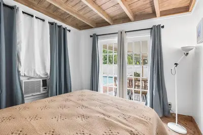 a bedroom with a bed and a window at Beach Home Estate I Pool & Ocean in Fort Lauderdale