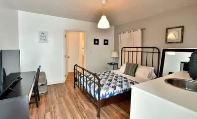 a bedroom with a bed and a sink in it at Krymwood Flats Wynwood in Miami