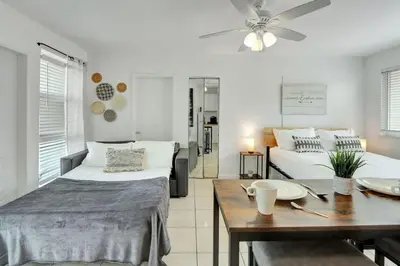 a living room with a bed and a dining table at Sunlit Studio Escape Hollywood Haven, sleeps 4 in Hollywood