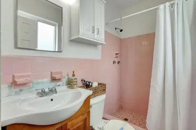 a pink bathroom with a sink and a toilet at Sunlit Studio Escape Hollywood Haven, sleeps 4 in Hollywood