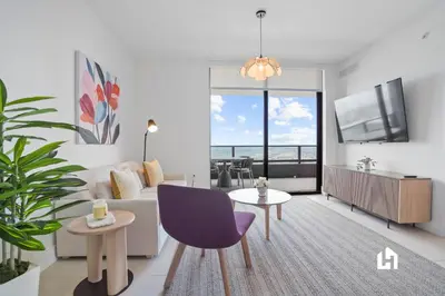 a living room with a couch and a tv at Stylish Apartments with Partial Ocean Views in Downtown! in Miami