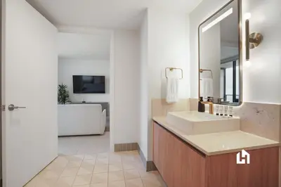 a bathroom with a sink and a mirror at Stylish Apartments with Partial Ocean Views in Downtown! in Miami