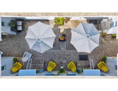 an overhead view of three umbrellas on a patio at Sun kissed Charm Beachside Hollywood Studio in Hollywood