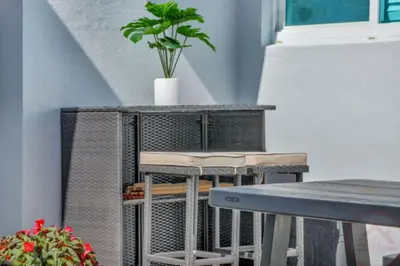 a table and chairs with a potted plant on top at Sun kissed Charm Beachside Hollywood Studio in Hollywood