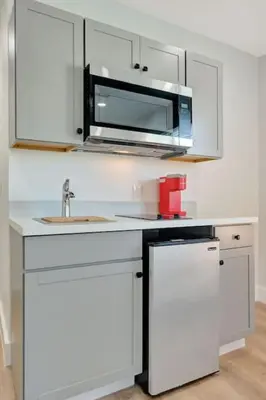 a kitchen with a sink and a microwave at Sun kissed Charm Beachside Hollywood Studio in Hollywood
