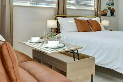 a bedroom with a bed and a table with drinks on it at Sandscape Haven Hollywood Beach Studio w Parking in Hollywood
