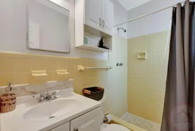 a bathroom with a sink and a toilet and a mirror at Studio Oasis near Hollywood Boardwalk in Hollywood