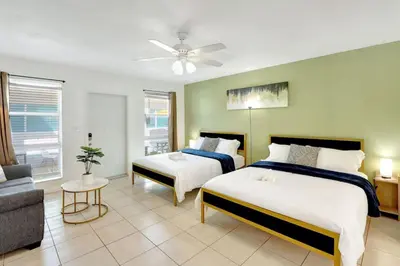 a bedroom with two beds and a living room at Hollywood Beach Escapade Studio with Free Parking in Hollywood