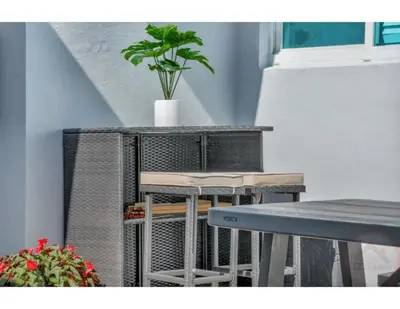 a table and chairs with a potted plant on top at Hollywood Beach Escapade Studio with Free Parking in Hollywood