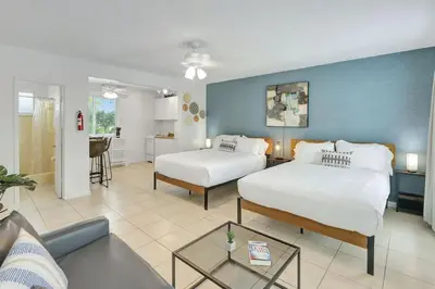 a bedroom with two beds and a living room at Coastal Retreat ONLY 1 block from the beach in Hollywood