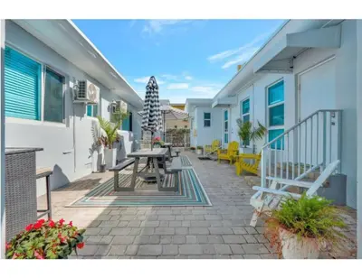 a patio with a table and benches on a building at Coastal Retreat ONLY 1 block from the beach in Hollywood