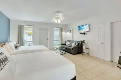 a large bedroom with two beds and a couch at Coastal Retreat ONLY 1 block from the beach in Hollywood