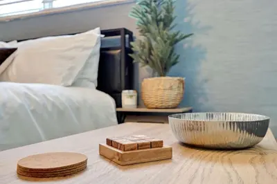 a table with a bowl on top of a bed at Coastal Comfort Hollywood Studio Retreat in Hollywood
