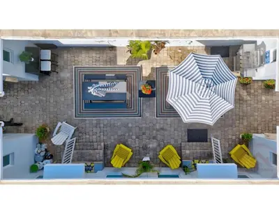a rendering of a patio with two umbrellas at Coastal Comfort Hollywood Studio Retreat in Hollywood