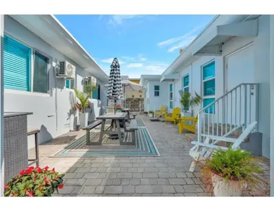 a patio with a table and benches on a building at Beachside Bliss Hollywood Studio in Hollywood