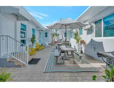 a patio with a table and an umbrella at Beachside Bliss Hollywood Studio in Hollywood