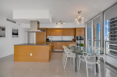 a kitchen with a table and chairs in a kitchen at Large Suites in Hotel W with bay views in Miami