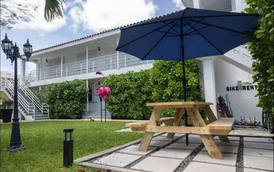 a picnic table with an umbrella in front of a building at B11 Design District Studio Short drive 2 beach in Miami