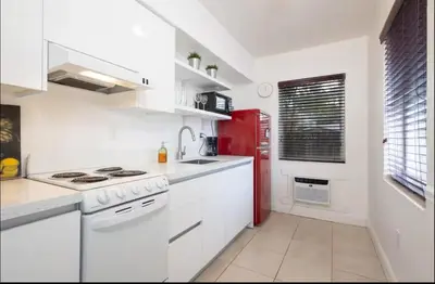 a kitchen with white counters and a red refrigerator at B11 Design District Studio Short drive 2 beach in Miami