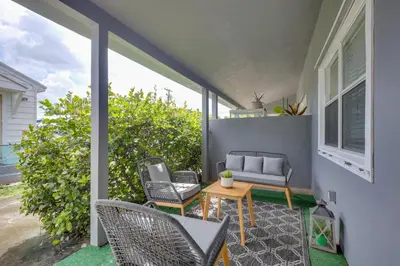 a patio with chairs and a couch and a table at 3 Mi to Beach Quaint Home with Patio in Hollywood in Hollywood