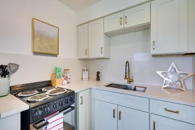a kitchen with white cabinets and a stove top oven at 3 Mi to Beach Quaint Home with Patio in Hollywood in Hollywood