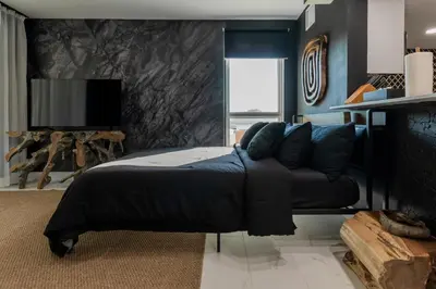 a bedroom with a bed with blue walls and a tv at MIAMI WOOD APART HOTEL NEW 2024 - PRIVATE TERRACE - free GARAGE - Beach 5 min in Hollywood