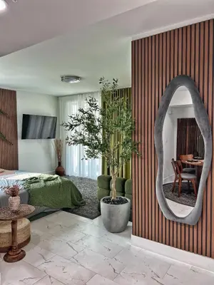 a bedroom with a bed and a mirror and a table at MIAMI WOOD APART HOTEL NEW 2024 - PRIVATE TERRACE - free GARAGE - Beach 5 min in Hollywood