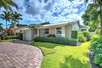 a house with a brick driveway in front of it at Gorgeous Las Olas - Heated Pool, Close to Beach in Fort Lauderdale