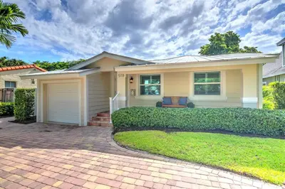 a house with a brick driveway in front of it at Gorgeous Las Olas - Heated Pool, Close to Beach in Fort Lauderdale
