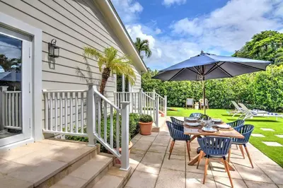 a patio with a table and an umbrella at Gorgeous Las Olas - Heated Pool, Close to Beach in Fort Lauderdale