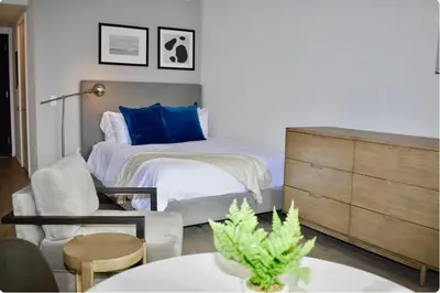 a bedroom with a bed and a chair and a table at The Bayfront III in Miami