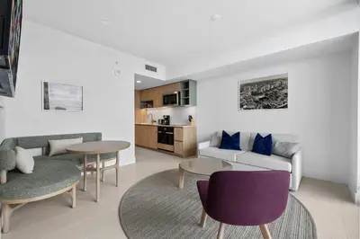 a living room with a couch and a table and chairs at Luxury Panoramic Views - The Ultimate Downtown Getaway in Miami