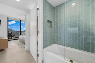 a bathroom with a tub and a bedroom at Luxury Panoramic Views - The Ultimate Downtown Getaway in Miami