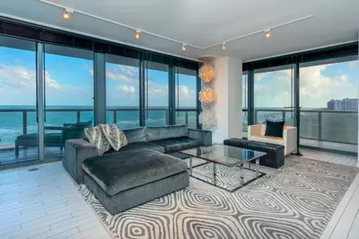 a living room with a couch and a table at Oceanfront 3B Private Residence at South Beach - 828 in Miami Beach