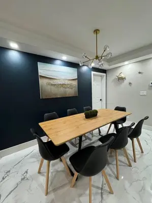 a dining room with a wooden table and chairs at 3Bd 2Bath 1 Block from the beach! Newly renovated in Fort Lauderdale