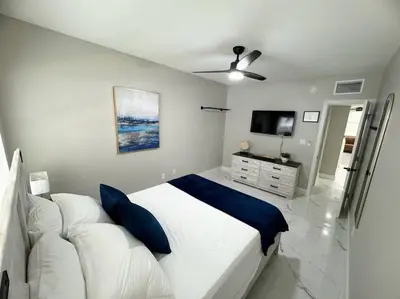 a white bedroom with a bed and a couch at 3Bd 2Bath 1 Block from the beach! Newly renovated in Fort Lauderdale
