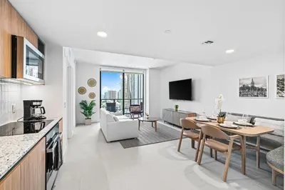 a kitchen and living room with a table and a dining room at New Luxury 26th Floor Apartment in the heart of Miami in Miami
