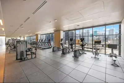 a gym with treadmills and exercise equipment in a building at Lux 2BR Natiivo Condo With Pool, Spa and Gym Access in Miami