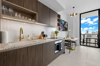 a kitchen with a sink and a counter with a desk at PH 49 Floor Luxury Studio w Free Parking in Miami