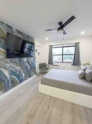 a bedroom with a large bed and a large painting at Beach Getaway in Hollywood
