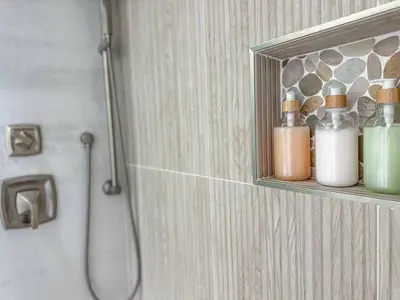 a bathroom with a shelf with bottles on a wall at Sunrise Delight 2 min walk to Beach Essentials in Hollywood