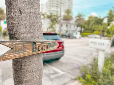 a sign on the side of a tree at Sunrise Delight 2 min walk to Beach Essentials in Hollywood