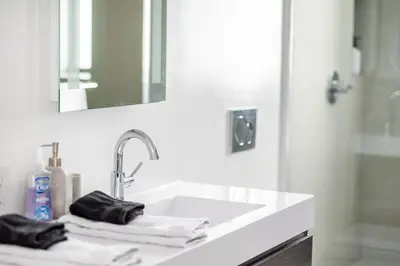 a white bathroom with a sink and a mirror at The Netherland 2A I Ocean Drive I MIAMI BEACH OCEAN RENTAL in Miami Beach