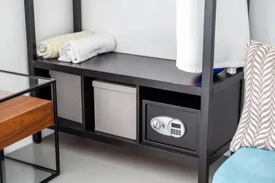 a black bunk bed with a microwave and a chair at The Netherland 2A I Ocean Drive I MIAMI BEACH OCEAN RENTAL in Miami Beach