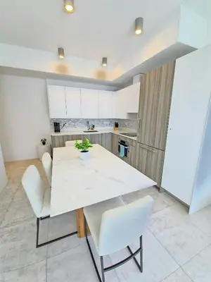 a kitchen with a white table and white chairs at Sleek New Brickell Condo With Free Parking - CS65 in Miami